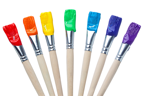 line of different colored paint brushes in a neat row