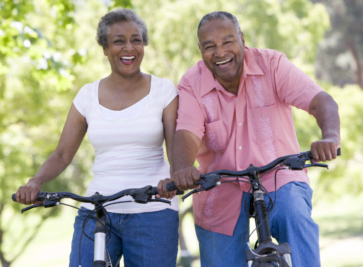 Senior couple on cycle ride in countryside.