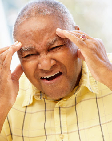 Senior man suffering from headache.