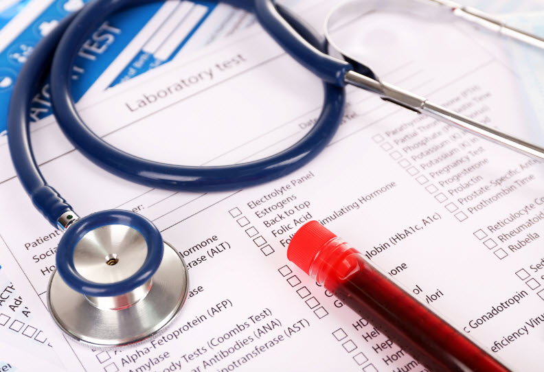 Blood in test tube, stethoscope and investigation form on table